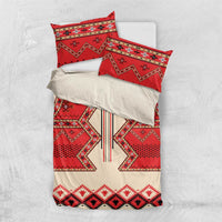 Bedding set flat lay: red, cream, and black patterned duvet cover with two pillow cases