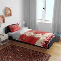 Bedding set on wooden bed: red and cream folk geometric duvet with matching pillow shams