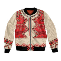 Beige bomber jacket with red folk geometric eagle-inspired front panel, zip and ribbed cuffs
