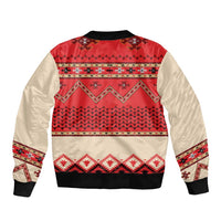 Red bomber jacket with folk geometric back panel, beige sleeves, zip front and ribbed hem