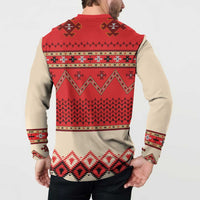 Beige folk print sweatshirt with red back panel, long sleeves, and patterned hem