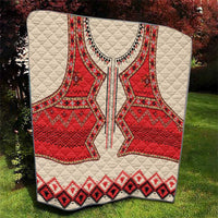 Beige quilt with red eagle center and black/red geometric banding, quilted surface