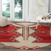 Round eagle motif carpet, beige ground with red geometric corners and central black stripe, LT18