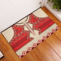 Red and beige folk eagle doormat with white zigzag trim, placed on indoor floor