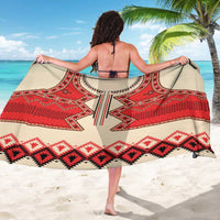 Beige sarong with red, black, and white geometric motif print, wide draped view
