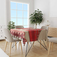 Beige tablecloth with red, white, and black geometric border on dining table