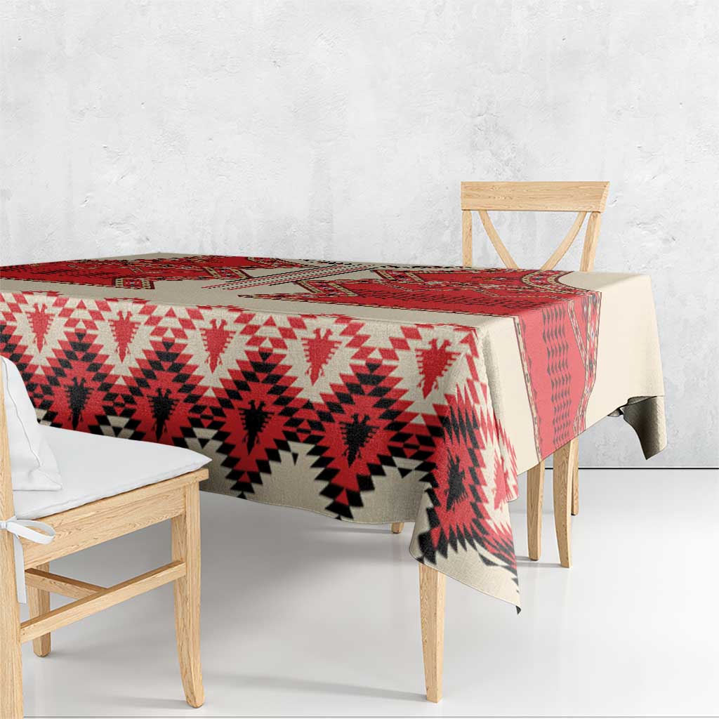 Beige tablecloth with red and white geometric print, overhanging edges