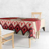 Beige tablecloth with red and white geometric print, overhanging edges