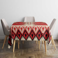 Beige round tablecloth with red, white, and black patterned surface