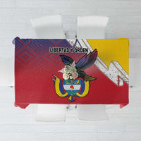 Folded red folk tablecloth with Colombian coat of arms, “LIBERTAD Y ORDEN” text, yellow panel