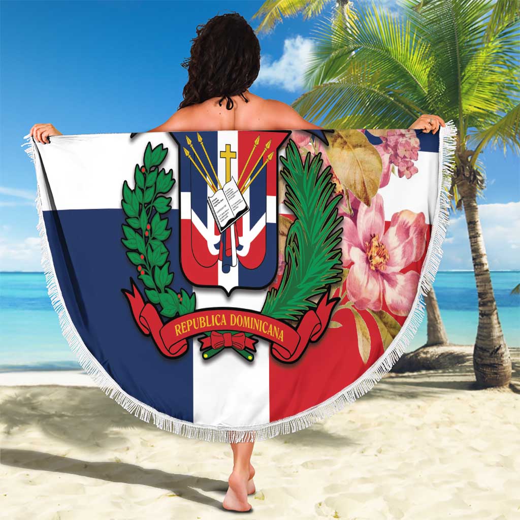 Round beach blanket with white fringe, Dominican crest on red/white/blue background with flowers