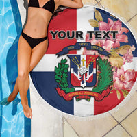 Round beach blanket with fringe border, custom text over Dominican crest and floral artwork
