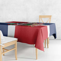 Red tablecloth with navy sides and central white stripe, featuring a colorful emblem