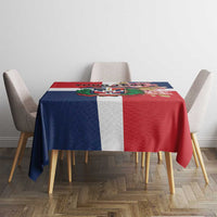 Red, navy and white printed tablecloth with colorful central artwork on dining table