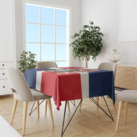 Red, navy and white printed tablecloth featuring colorful emblem on dining table