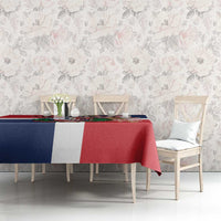 Red, navy and white printed tablecloth draped on dining table with central artwork