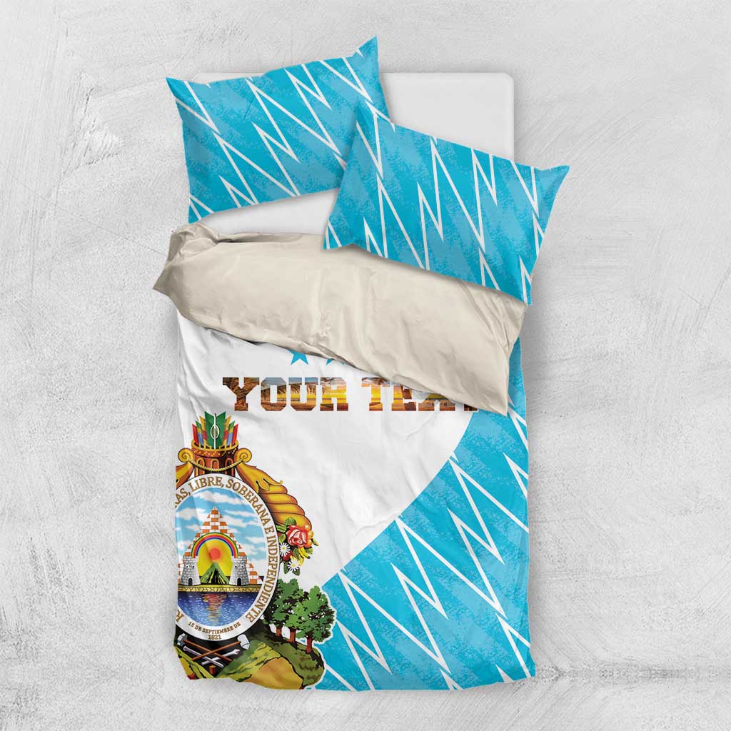 Personalized bedding set with blue geometric flag pattern, white center, crest, “YOUR TEXT”