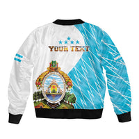 Bomber jacket back with crest emblem, diagonal blue pattern, black ribbed cuffs, white