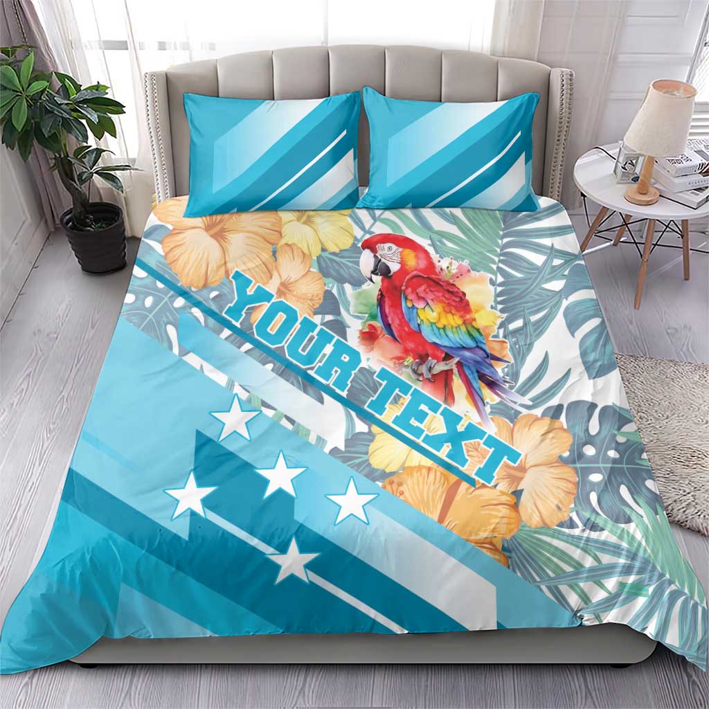 Blue bedding set on bed with parrot and hibiscus design, star-spangled stripes, two pillowcases