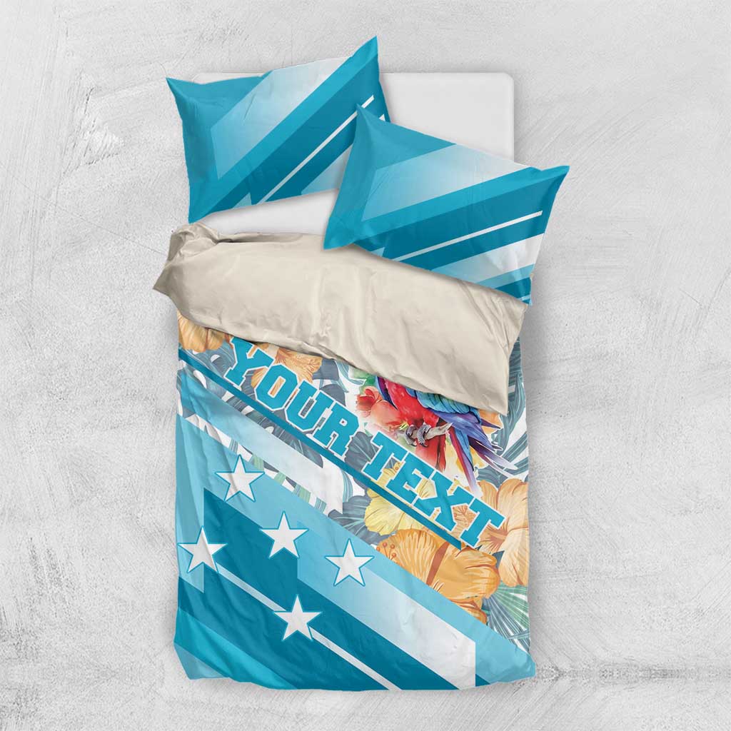 Blue bedding set flat lay with parrot and hibiscus print, star-spangled stripes, pillowcases included