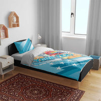 Blue bedding set on bed with parrot and hibiscus artwork, star-spangled stripes, duvet and pillows