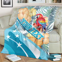 Personalized blue blanket with macaw and tropical flowers, plus diagonal ROATAN lettering
