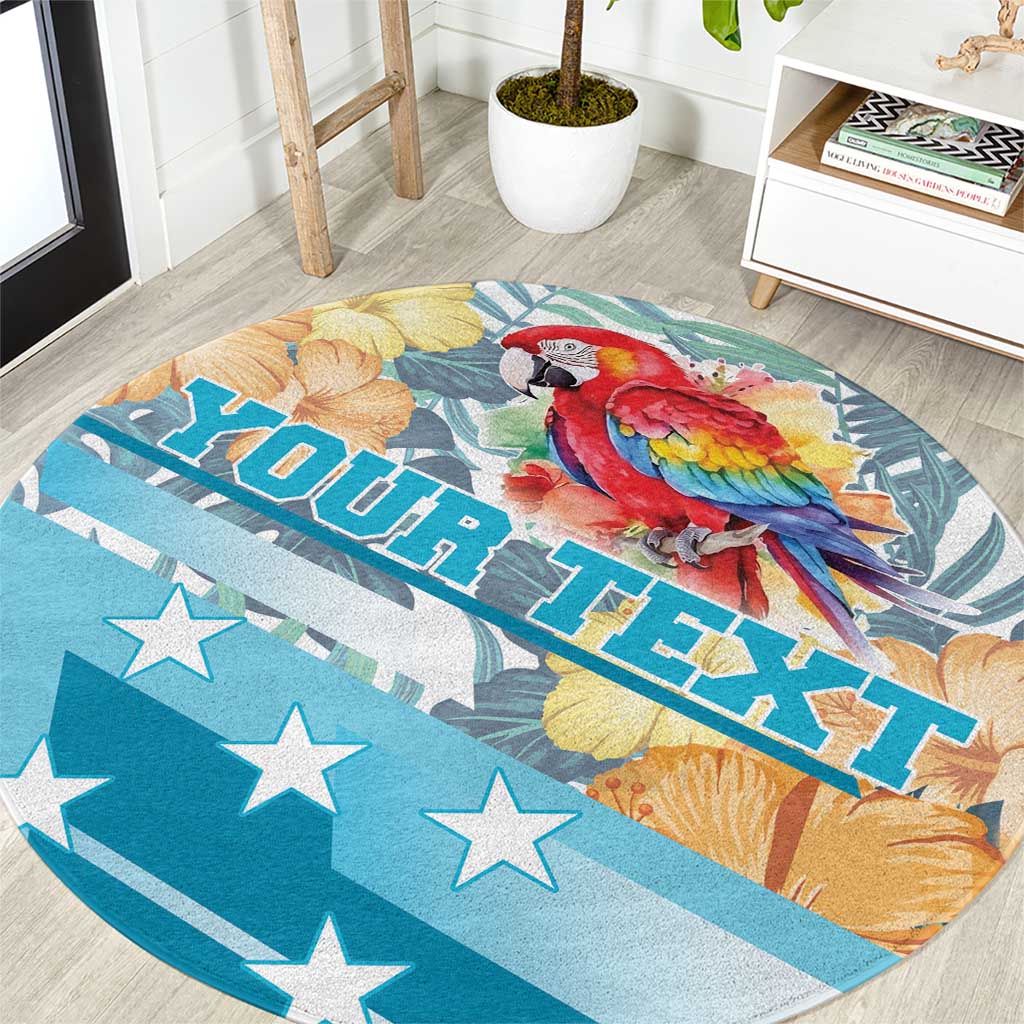 Round carpet with scarlet macaw, ROATAN HONDURAS lettering, tropical leaf flowers