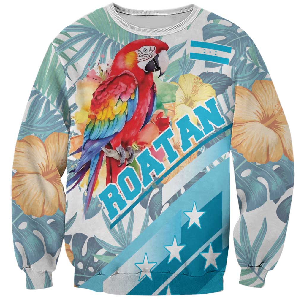 Unisex tropical sweatshirt with red-blue macaw, hibiscus, teal leaf print, diagonal Roatan text