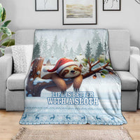 Blue sloth holiday throw blanket on a gray sofa with trees and Santa sloth