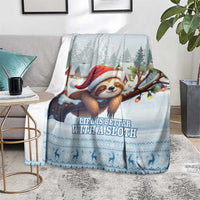 Blue sloth holiday blanket covering a chair with Santa sloth and character silhouettes