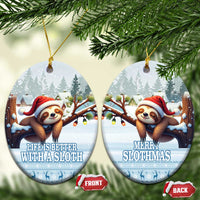 Blue ceramic round sloth ornaments hanging side by side, Santa sloth and snowy forest.