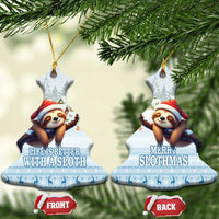 Blue ceramic bell-shaped sloth ornament hanging, Santa sloth in snowy forest scene.