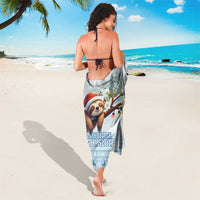 Blue sloth beach sarong with tall sloth portrait, winter motifs, and blue patterned hem