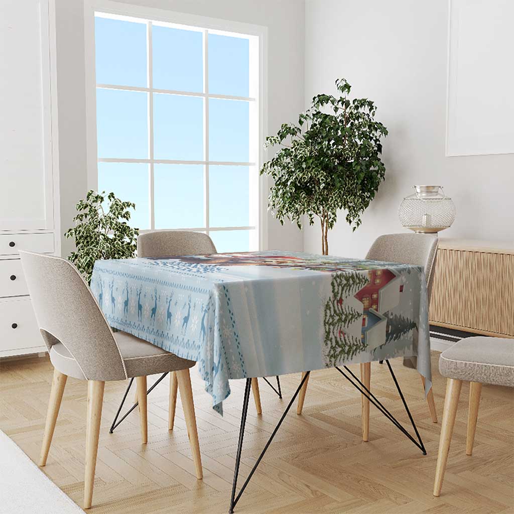 Blue winter silhouette tablecloth with patterned border, draped on dining table