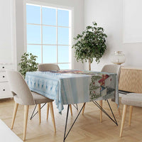 Blue winter silhouette tablecloth with patterned border, draped on dining table