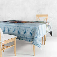 Blue winter silhouette tablecloth draped over table with visible printed figures