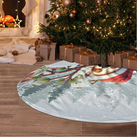 Blue circular Christmas tree skirt with sloth holiday print and white tassel fringe