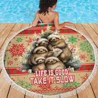 Round beach blanket with sloth family holiday print and fringe edge, “Life is good” text