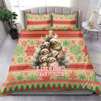 Christmas bedding set featuring sloths on red, green, and cream striped snowflake pattern