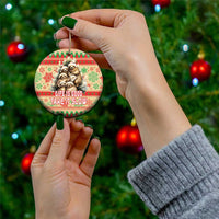 Red and green circle ceramic ornament with sloths and “Life Is Good, Take It Slow” held by hand
