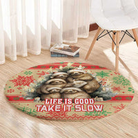 Red round Christmas floor rug with sloth image and 'Life is Good, Take It Slow' text