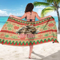 Red, green, and cream sloth-themed Christmas sarong with central sloth artwork and border