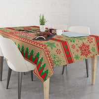 Red Christmas tablecloth with green tree and snowflake pattern on dining table