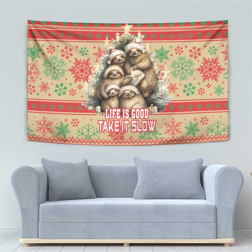Christmas sloth wall tapestry with red-green festive pattern and text “Life is good, take it slow”