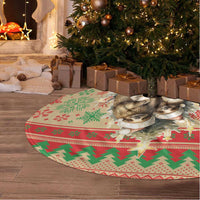 Red and green sloth Christmas tree skirt with fringe edge and holiday pattern