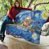 Blue sloth quilt draped over sofa, starry floral print with "Just Do It Later..."