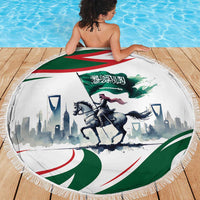 Round green beach blanket with Saudi flag, horse rider artwork, and fringed edge