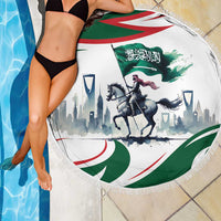 Round fringed beach blanket with Saudi flag and horse rider graphic, draped over person
