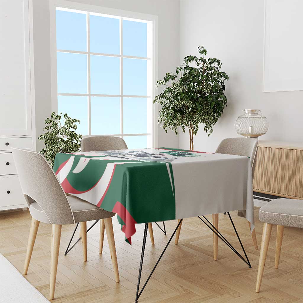 Green tablecloth with horse-rider design and red/white curved stripes on dining table