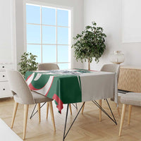 Green tablecloth with horse-rider design and red/white curved stripes on dining table